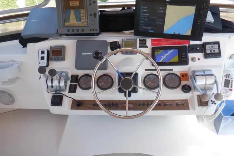 Slide: The Image of 2002 Mainship 430 Trawler helm with navigation equipment and steering wheel. - 25
