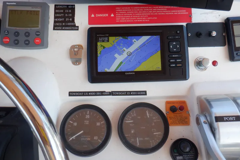 Slide: The Image of Control panel of a 2002 Mainship 430 Trawler with navigation and monitoring instruments. - 28