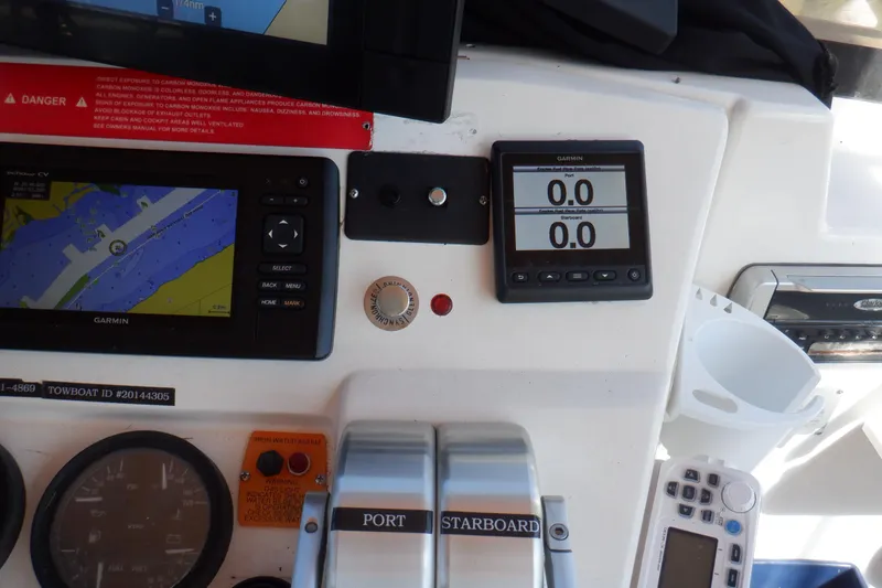 Slide: The Image of Mainship 430 Trawler 2002 dashboard with Garmin navigation and control instruments. - 29
