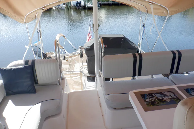 Slide: The Image of 2002 Mainship 430 Trawler interior with seating and water view. - 30