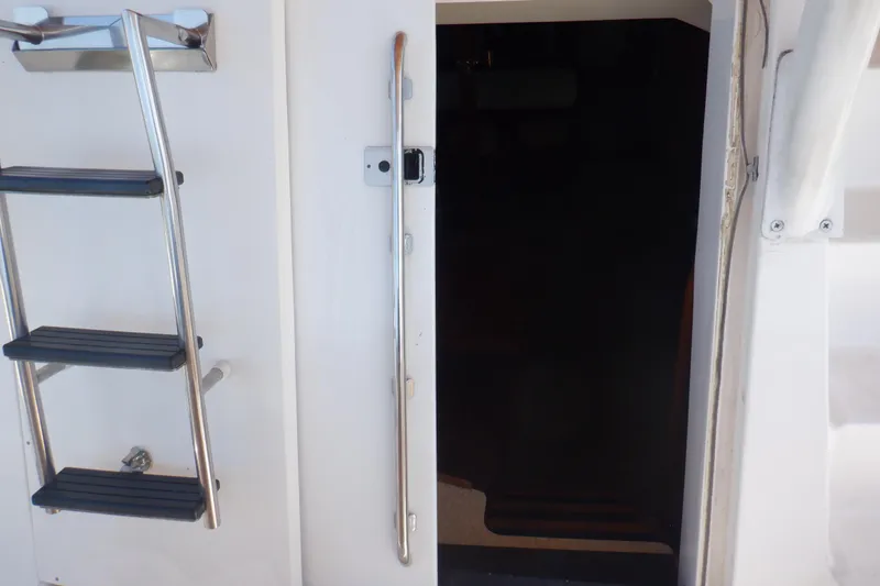 Slide: The Image of Stainless steel ladder and open door on 2002 Mainship 430 Trawler yacht. - 31