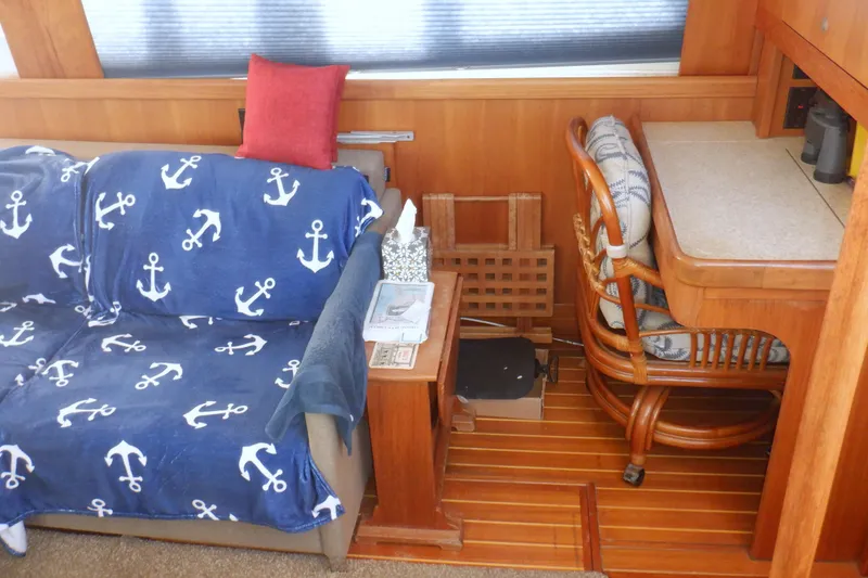 Slide: The Image of Interior of 2002 Mainship 430 Trawler with nautical-themed decor and wooden furnishings. - 40
