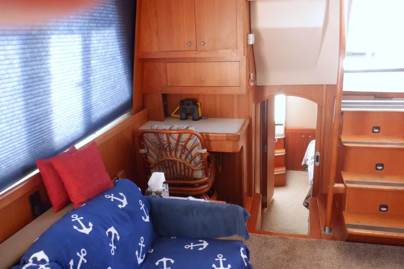 Slide: The Image of Interior of 2002 Mainship 430 Trawler with nautical-themed decor and wooden furnishings. - 41