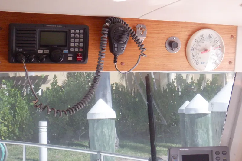 Slide: The Image of 2002 Mainship 430 Trawler interior with radio and thermometer on wooden panel. - 45