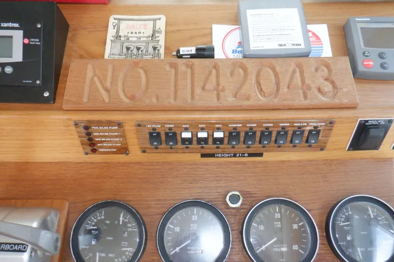 Slide: The Image of Control panel of a 2002 Mainship 430 Trawler with gauges and switches. - 48