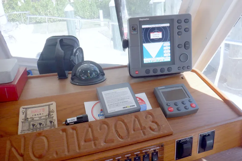 Slide: The Image of Control panel of a 2002 Mainship 430 Trawler with navigation equipment. - 49