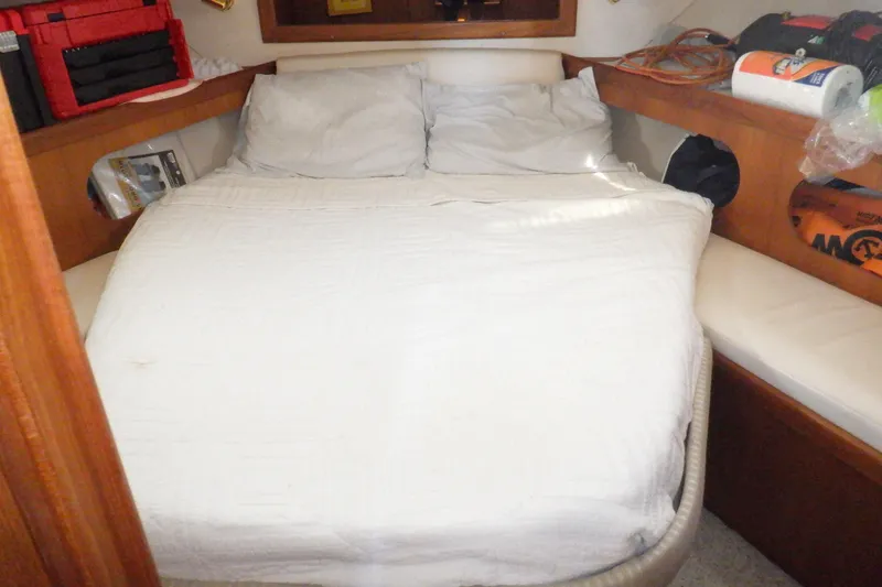 Slide: The Image of Cozy cabin interior of 2002 Mainship 430 Trawler with a neatly made bed. - 55