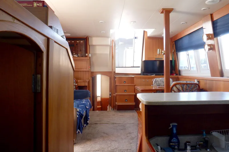 Slide: The Image of Interior of 2002 Mainship 430 Trawler with wood furnishings and natural light. - 60