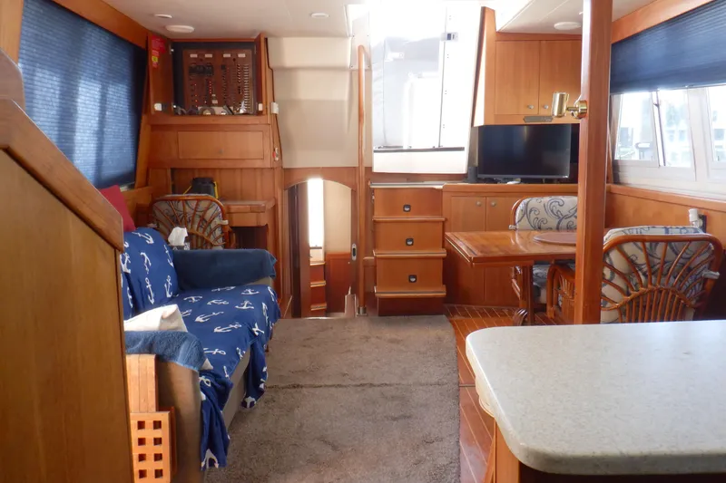 Slide: The Image of Interior of 2002 Mainship 430 Trawler with cozy seating and dining area. - 61