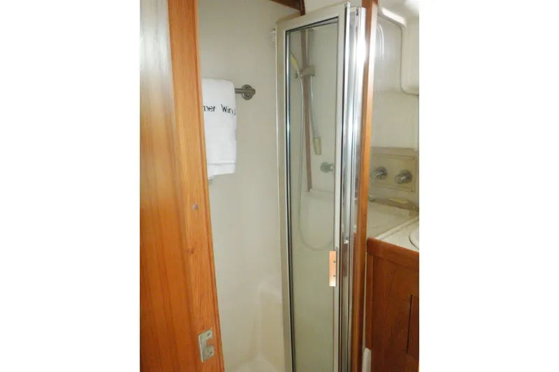 Slide: The Image of 2002 Mainship 430 Trawler bathroom with shower and wooden cabinetry. - 67