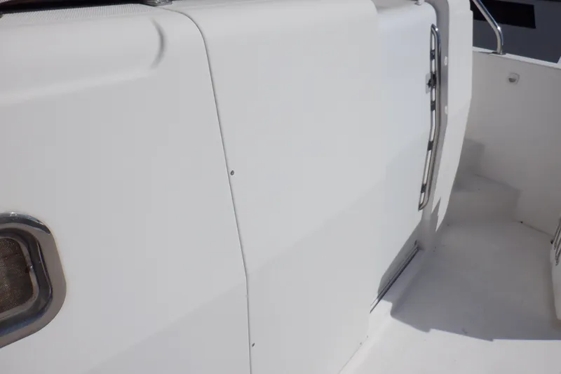 Slide: The Image of 2002 Mainship 430 Trawler, white exterior with stainless steel railing and door. - 7