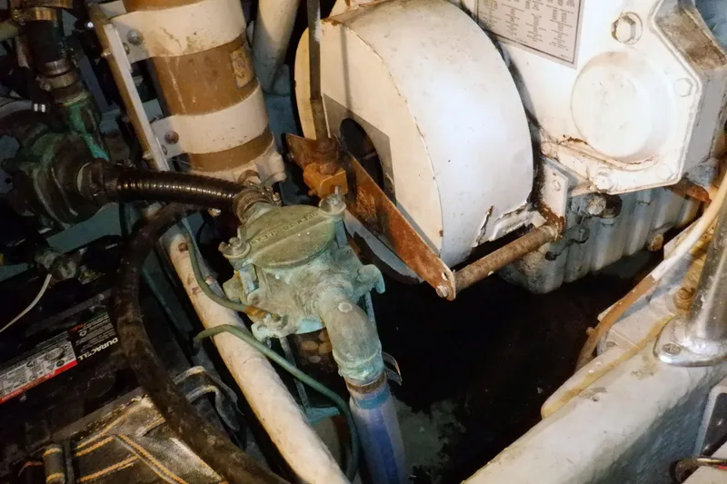 Slide: The Image of Engine room of 2002 Mainship 430 Trawler, featuring mechanical components and piping. - 71