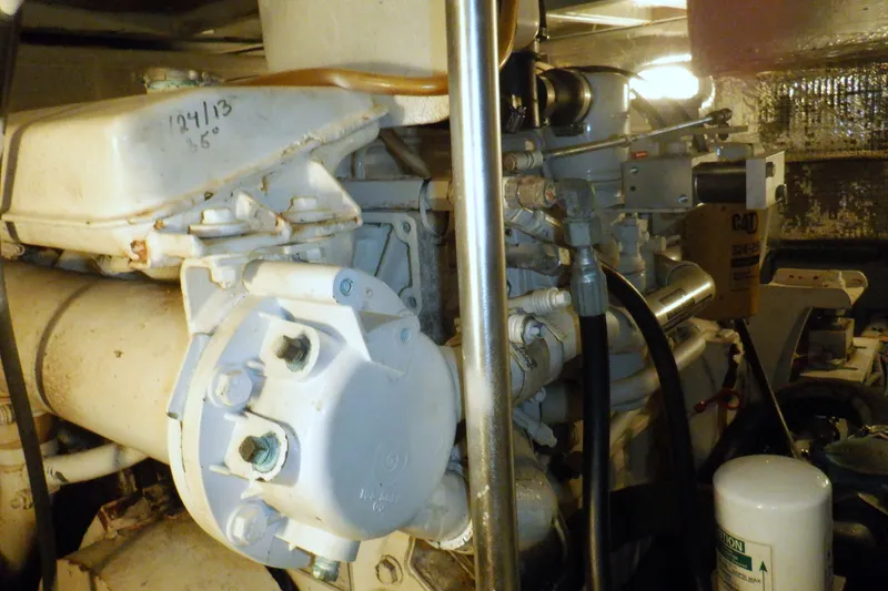 Slide: The Image of Engine room of 2002 Mainship 430 Trawler, showcasing mechanical components and piping. - 72