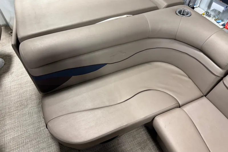 Slide: The Image of 2020 Bennington SX 22 SLX boat interior seating with beige upholstery and cup holder. - 12