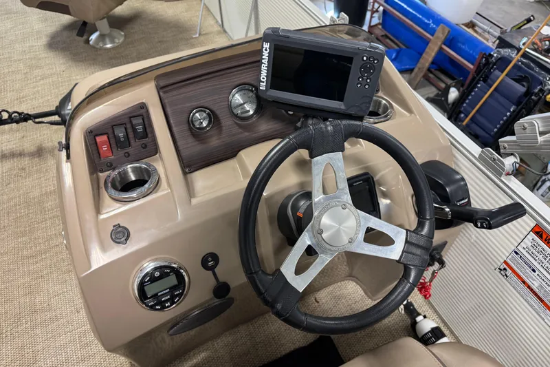 Slide: The Image of 2020 Bennington SX 22 SLX boat dashboard with steering wheel and Lowrance display. - 13