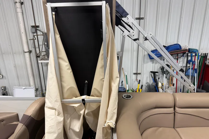 Slide: The Image of 2020 Bennington SX 22 SLX boat interior with folded canopy and beige seating. - 21