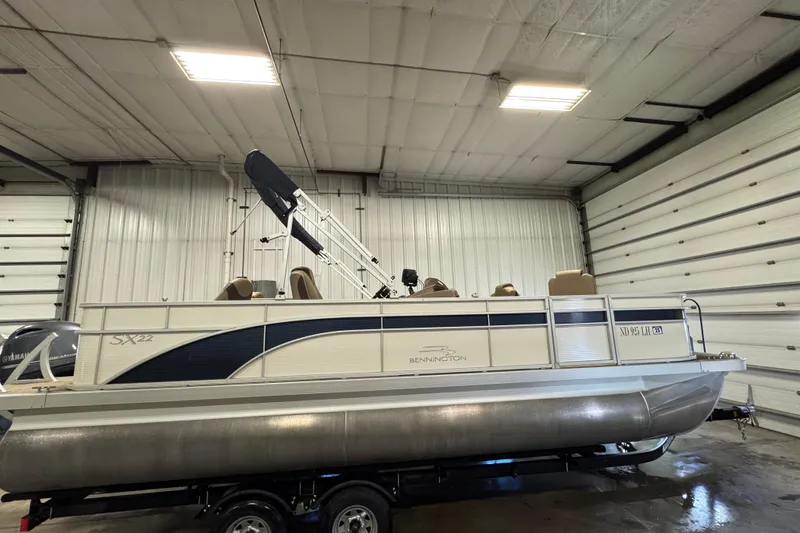 Slide: The Image of 2020 Bennington SX 22 SLX pontoon boat in a garage, side view. - 3