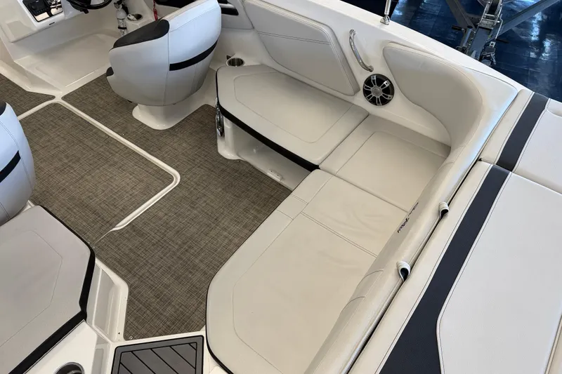 Slide: The Image of 2020 Sea Ray SPX 210 boat interior with white seating and modern design. - 10