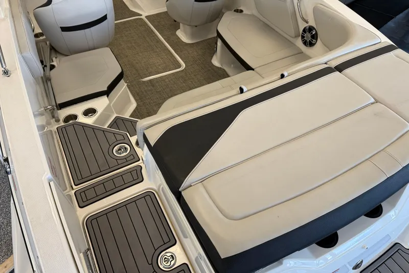 Slide: The Image of 2020 Sea Ray SPX 210 boat interior with beige seating and black accents. - 11
