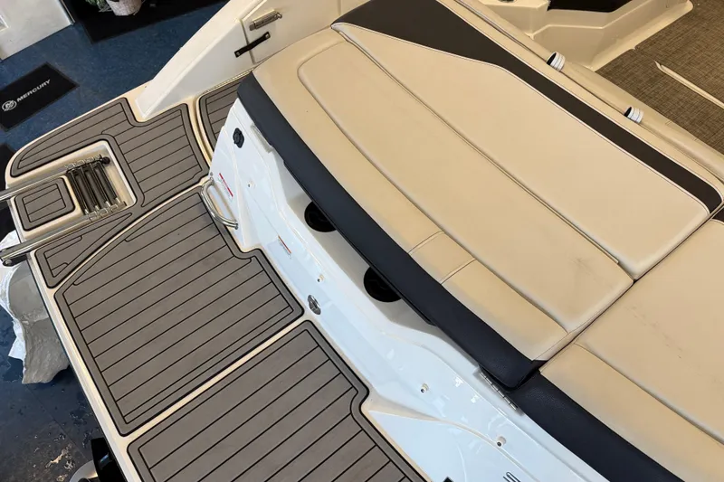 Slide: The Image of 2020 Sea Ray SPX 210 boat deck with beige seating and gray flooring. - 12