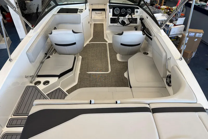 Slide: The Image of 2020 Sea Ray SPX 210 boat interior with white seating and modern dashboard. - 13