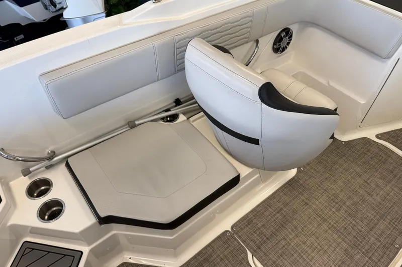 Slide: The Image of 2020 Sea Ray SPX 210 boat interior with cushioned seating and cup holders. - 5