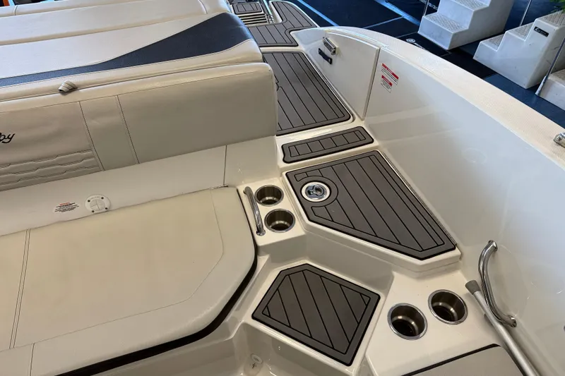 Slide: The Image of 2020 Sea Ray SPX 210 boat interior with cushioned seating and cup holders. - 7