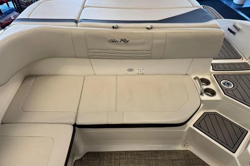 Slide: The Image of 2020 Sea Ray SPX 210 boat interior with beige seating and cup holders. - 8