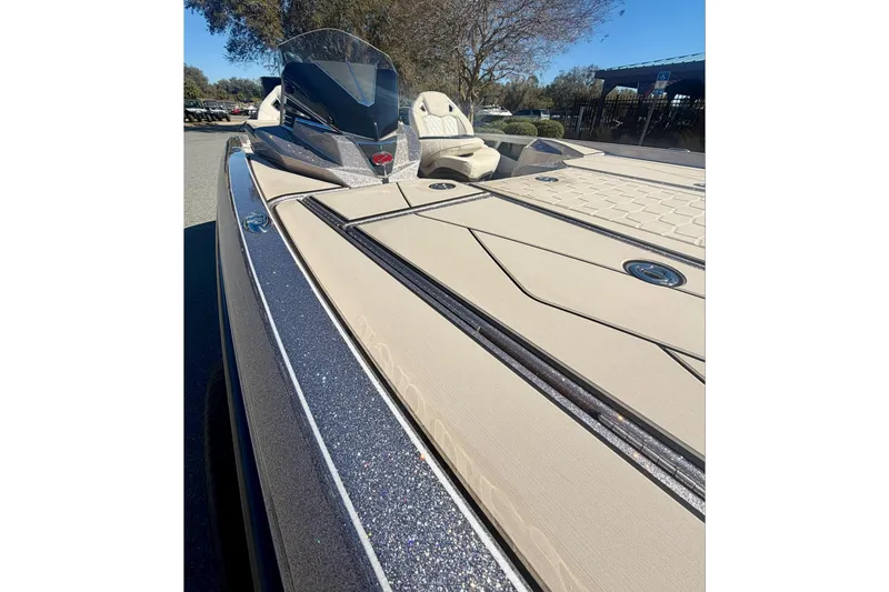 Slide: The Image of 2026 Ranger Z520R Ultra boat with sleek design and spacious deck, parked outdoors. - 14