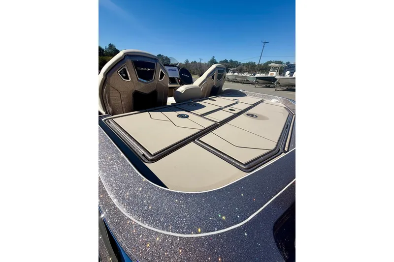 Slide: The Image of 2026 Ranger Z520R Ultra boat deck with storage compartments under clear blue sky. - 16
