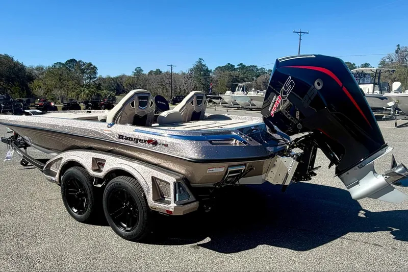 Slide: The Image of 2026 Ranger Z520R Ultra boat with powerful outboard motor, parked outdoors. - 7