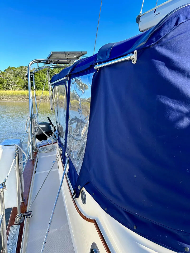 Slide: The Image of 2006 Island Packet 440 sailboat with blue canopy on deck. - 21