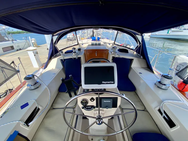 Slide: The Image of Island Packet 440 sailboat cockpit, 2006 model, featuring steering wheel and navigation system. - 8