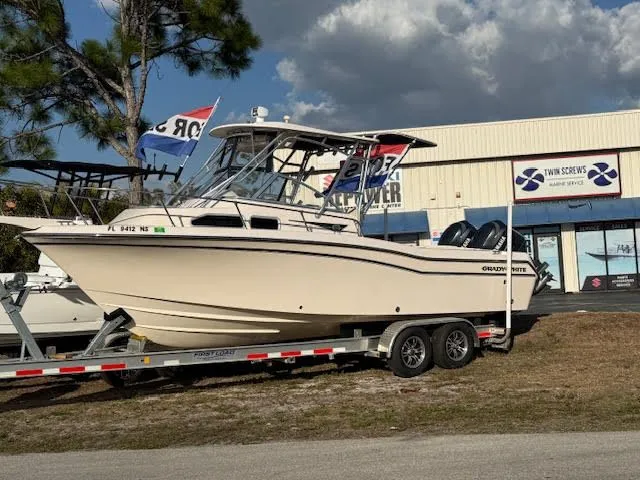 Slide: The Image of 2008 Grady-White Journey 258 boat on trailer in front of store. - 6