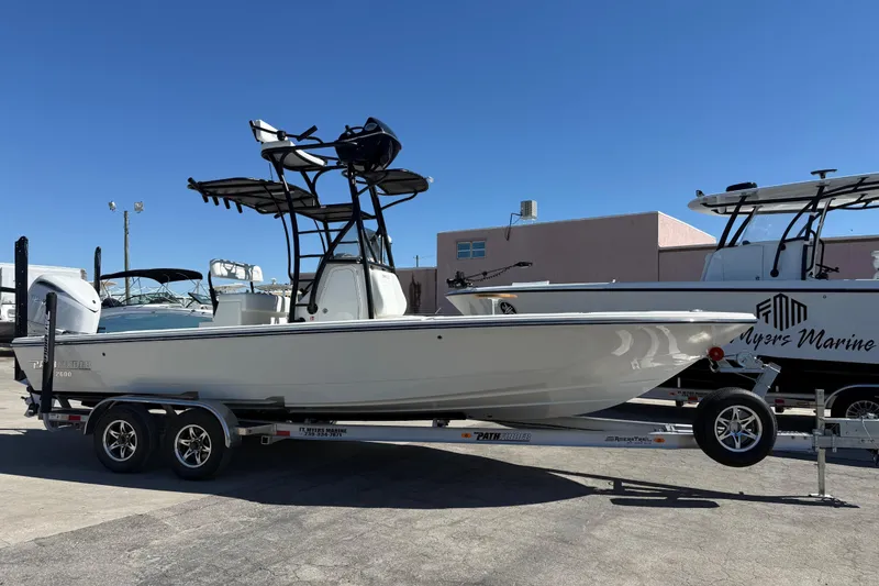 Slide: The Image of 2026 Pathfinder 2600 TRS boat on trailer, displayed outdoors under clear blue sky. - 1
