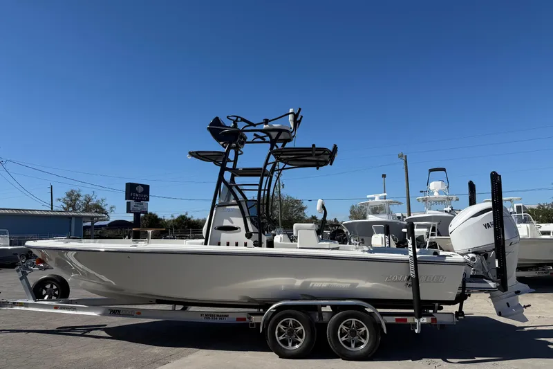 Slide: The Image of 2026 Pathfinder 2600 TRS boat on trailer under clear blue sky. - 11