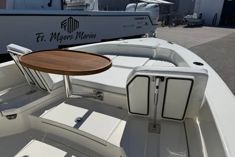 Slide: The Image of 2026 Pathfinder 2600 TRS boat interior with wooden table at Ft. Myers Marine. - 18