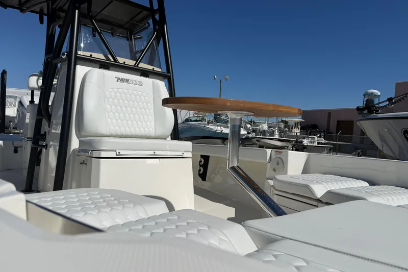 Slide: The Image of 2026 Pathfinder 2600 TRS boat interior with white seating and wooden table. - 3