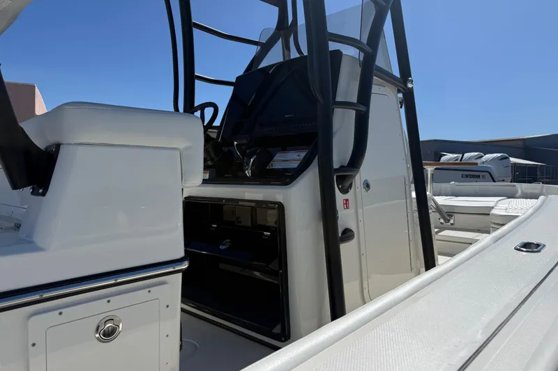 Slide: The Image of 2026 Pathfinder 2600 TRS boat interior with console and seating, under clear blue sky. - 4