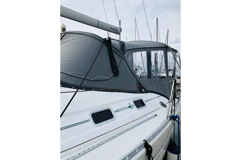 Slide: The Image of Sailboat Beneteau 381, 1998 model, docked with protective canopy, side view. - 10
