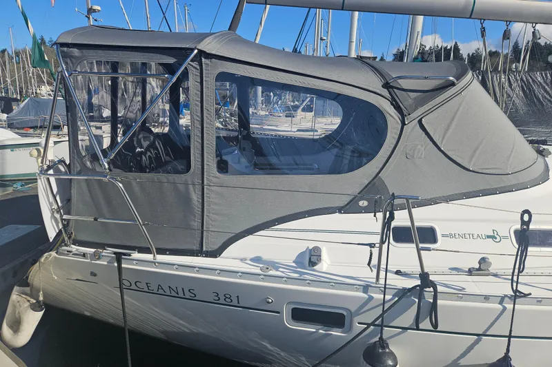 Slide: The Image of 1998 Beneteau Oceanis 381 sailboat with gray canopy docked at marina. - 12