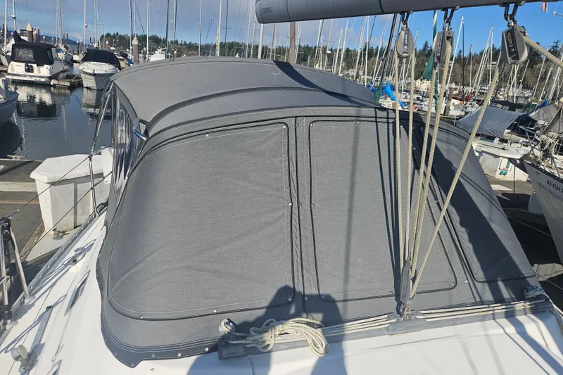 Slide: The Image of Sailboat Beneteau 381 (1998) with gray canopy docked at marina. - 13