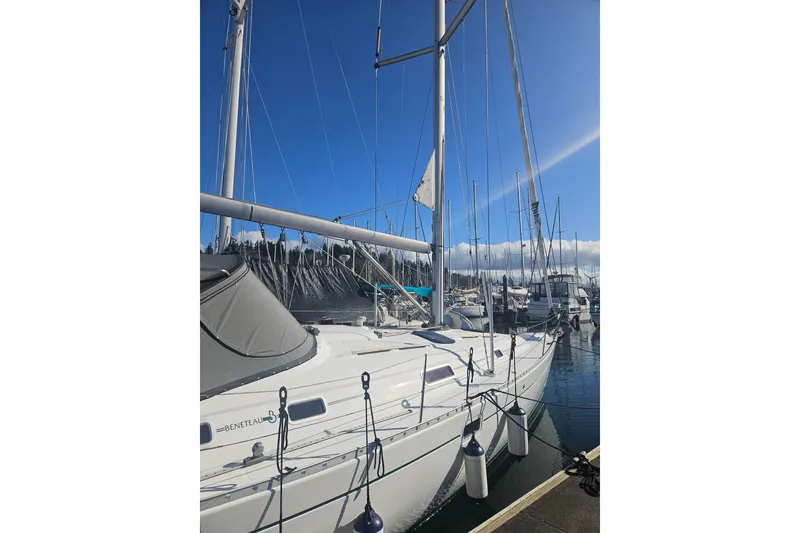 Slide: The Image of Sailboat Beneteau 381, 1998 model, docked at marina under clear blue sky. - 14