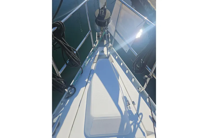 Slide: The Image of Deck view of a 1998 Beneteau 381 sailboat with ropes and railing. - 16
