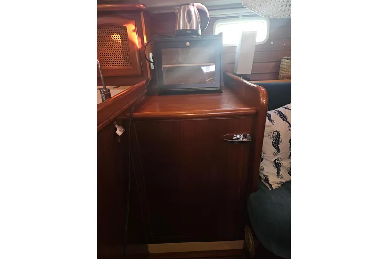 Slide: The Image of Interior of 1998 Beneteau 381 sailboat with wooden cabinetry and compact kitchen appliances. - 31