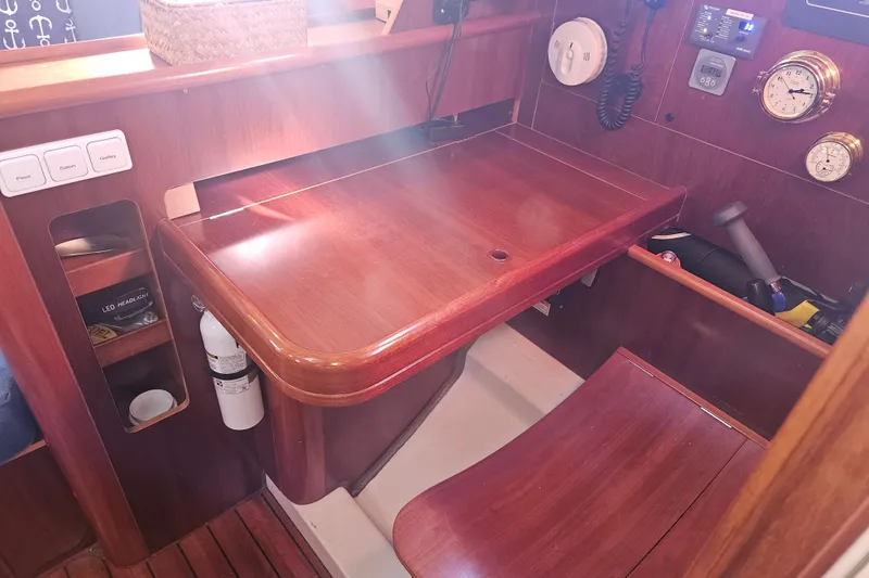 Slide: The Image of Navigation station of a 1998 Beneteau 381 sailboat with wooden desk and instruments. - 33
