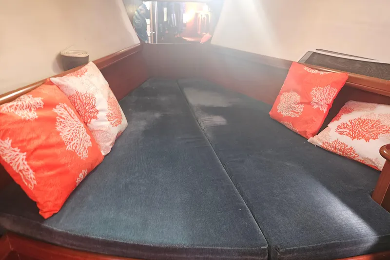 Slide: The Image of Cozy cabin interior of 1998 Beneteau 381 sailboat with colorful coral-patterned pillows. - 40