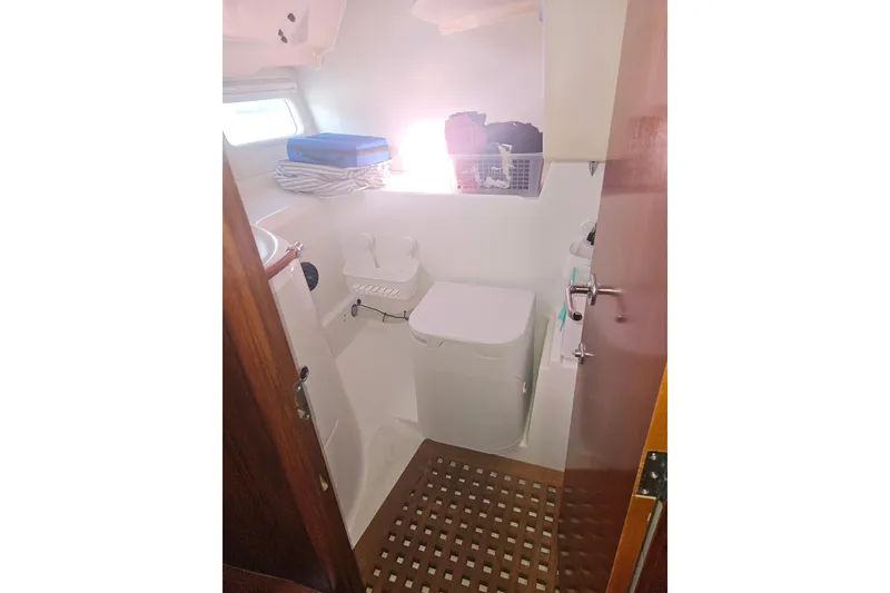 Slide: The Image of Bathroom interior of a 1998 Beneteau 381 sailboat, featuring compact design and storage. - 43