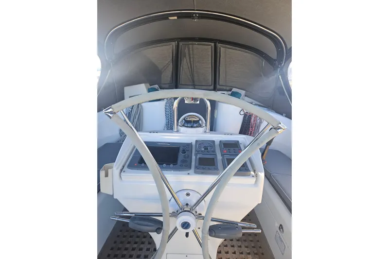 Slide: The Image of Cockpit of 1998 Beneteau 381 sailboat with steering wheel and navigation instruments. - 46