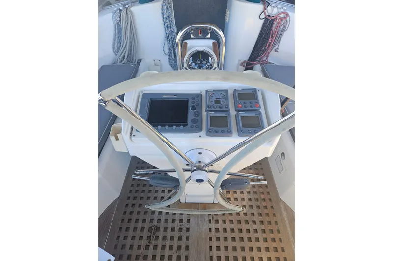 Slide: The Image of Cockpit of 1998 Beneteau 381 sailboat with navigation instruments and steering wheel. - 47